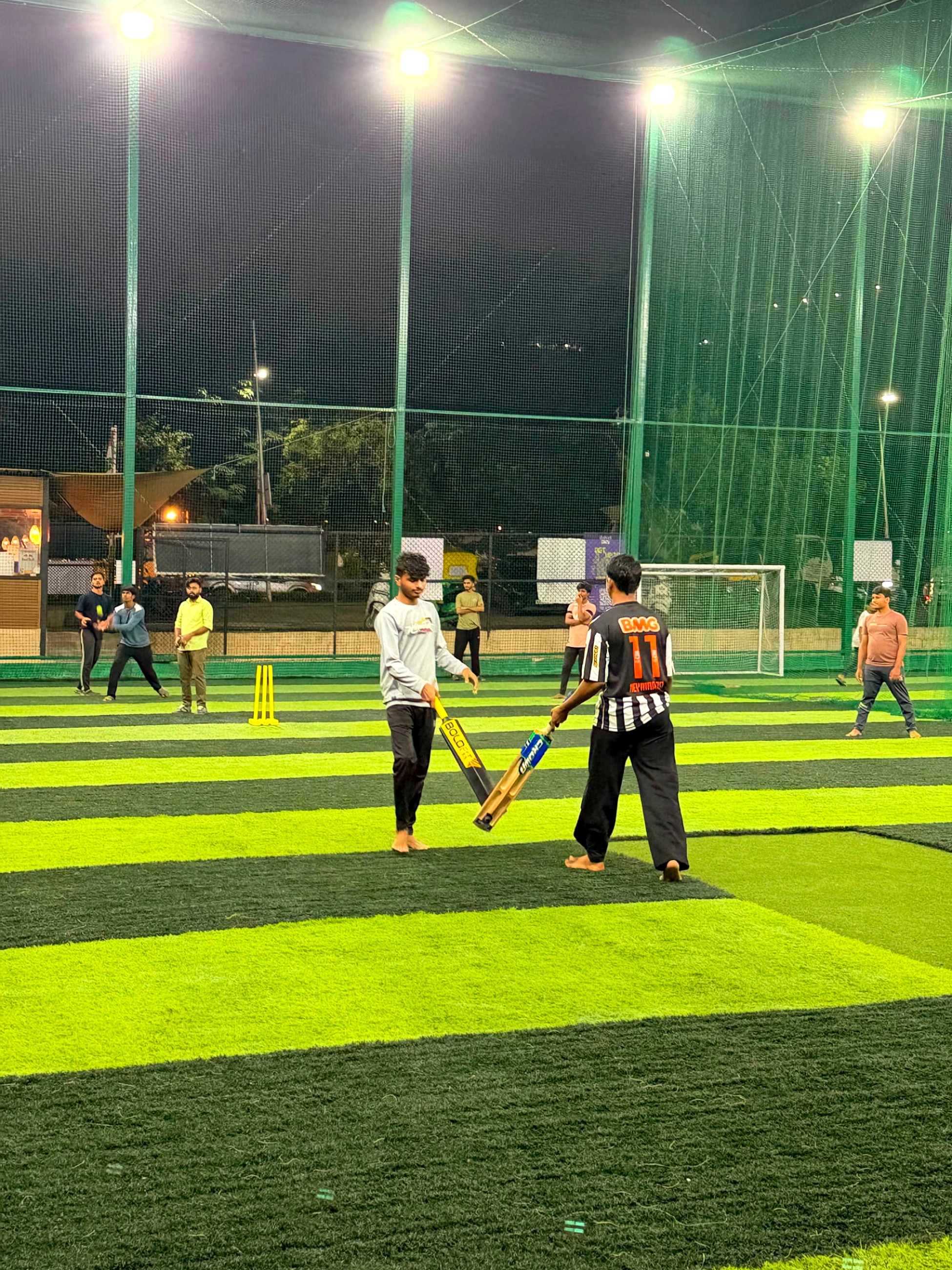 Two batters walking out at the Hostel Premiere League turf night
