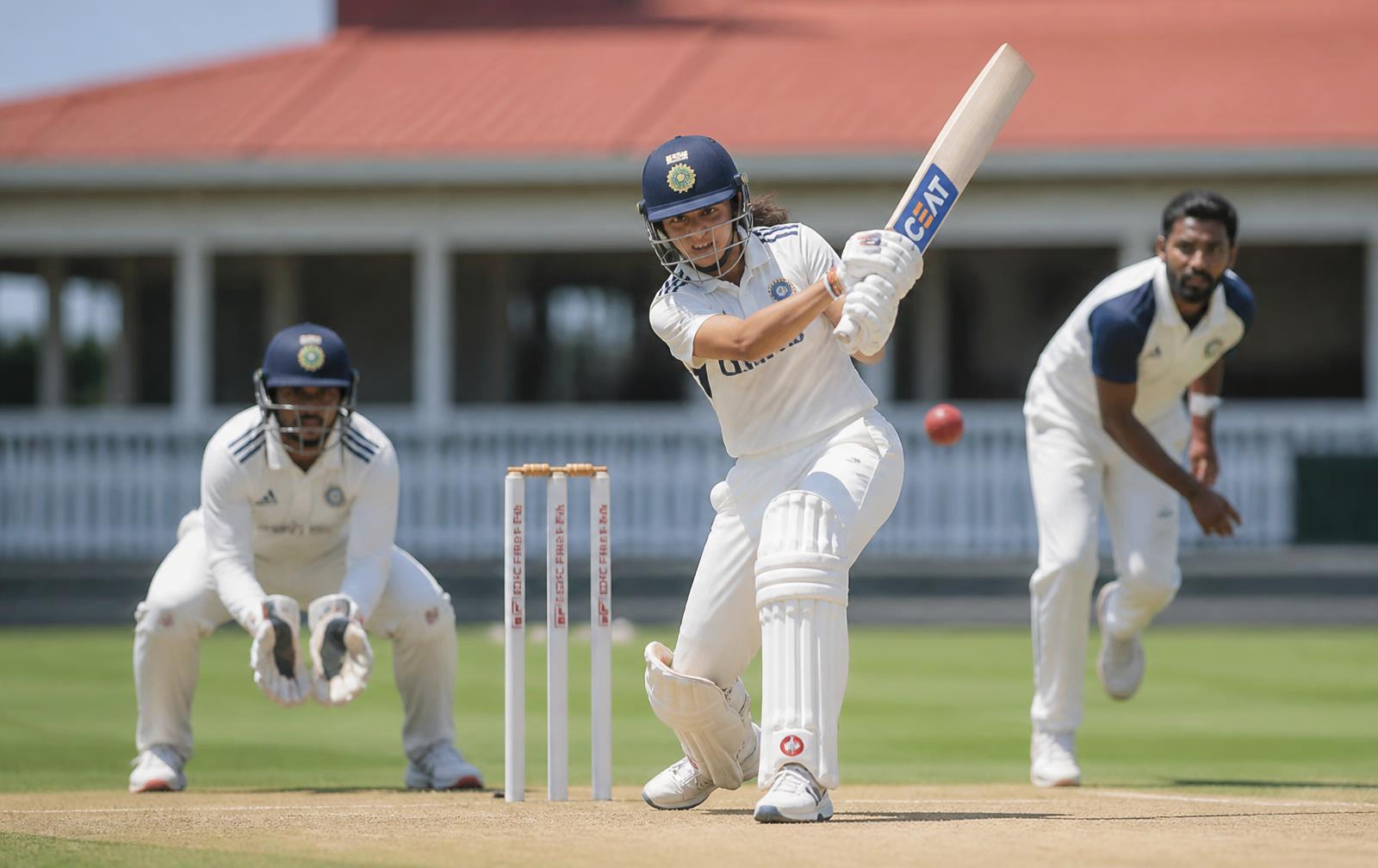 Indian men and women playing a friendly cricket match in whites